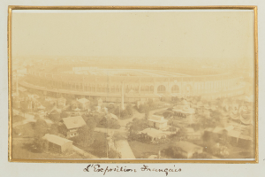 Altes Schwarz-Weiß-Foto eines Stadions in städtischer Umgebung mit umliegenden Gebäuden, Bäumen und Strommasten; unten sichtbarer Text.