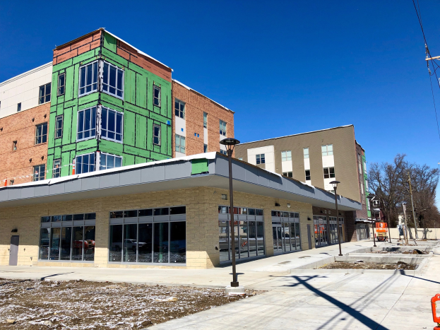 Großes mehrstöckiges Gebäude mit zahlreichen Fenstern, Teil des Campus der University of Wisconsin-Madison, umgeben von Straßeninfrastruktur, Fahrzeugen, Bäumen und einem bewölkten Himmel.